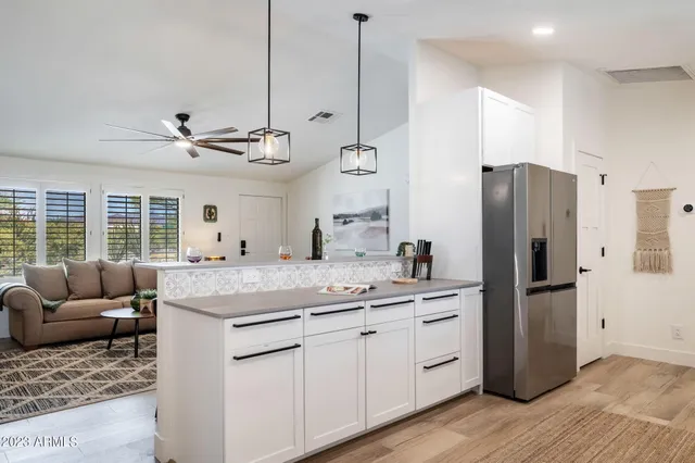 a room with cabinets a sink and appliances