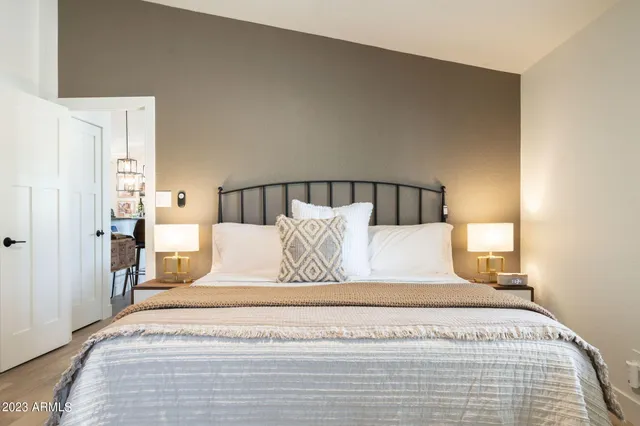 a bedroom with a bed and a night stand