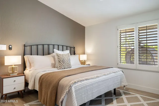 a bedroom with a bed and a flat screen tv