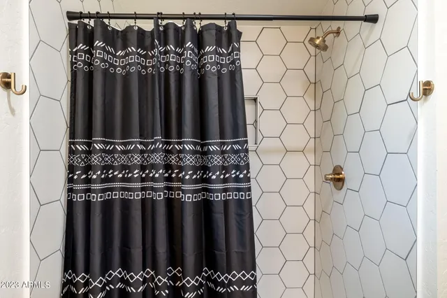 a bedroom with a bed and a brick wall