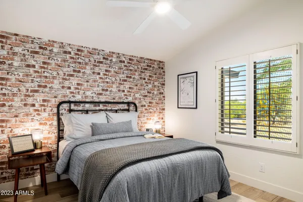 a bedroom with a bed and a black white checkered floor