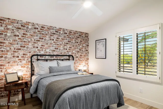 a bedroom with a bed and a black white checkered floor