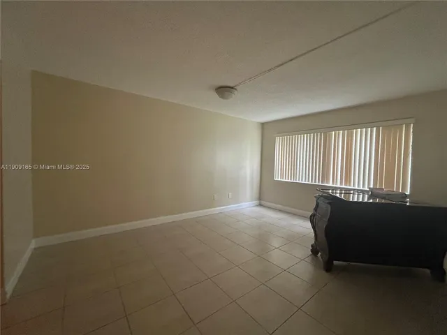 a spacious bedroom with a bed and a window