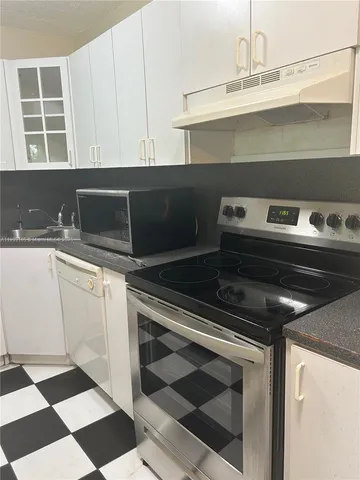 a kitchen with a stove and a sink