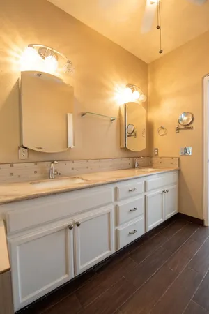 a spacious bathroom with a granite countertop sink and a mirror