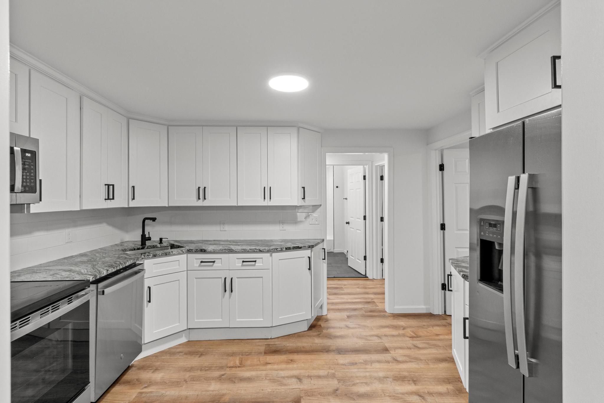 5 Pine Trail Avon, CT 06001 - Photo 13 of 26 a kitchen with a sink stove and refrigerator