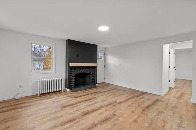 a view of empty room with a fireplace