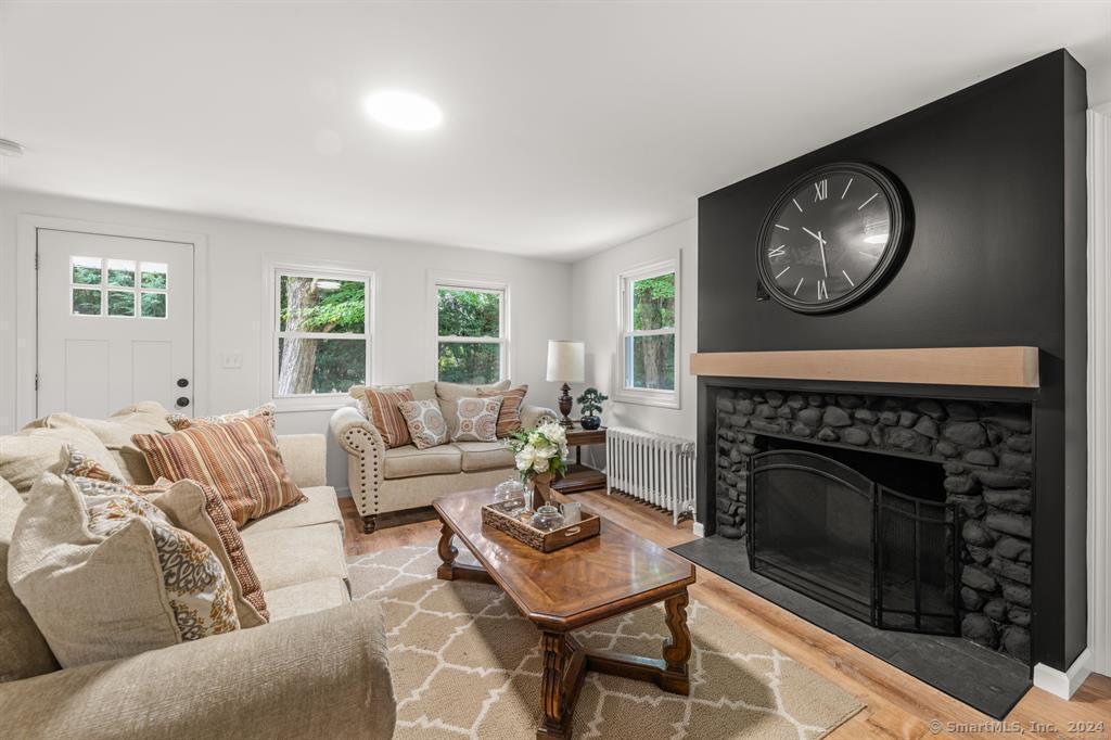 5 Pine Trail Avon, CT 06001 - Photo 7 of 26 a living room with furniture a fireplace and a large window