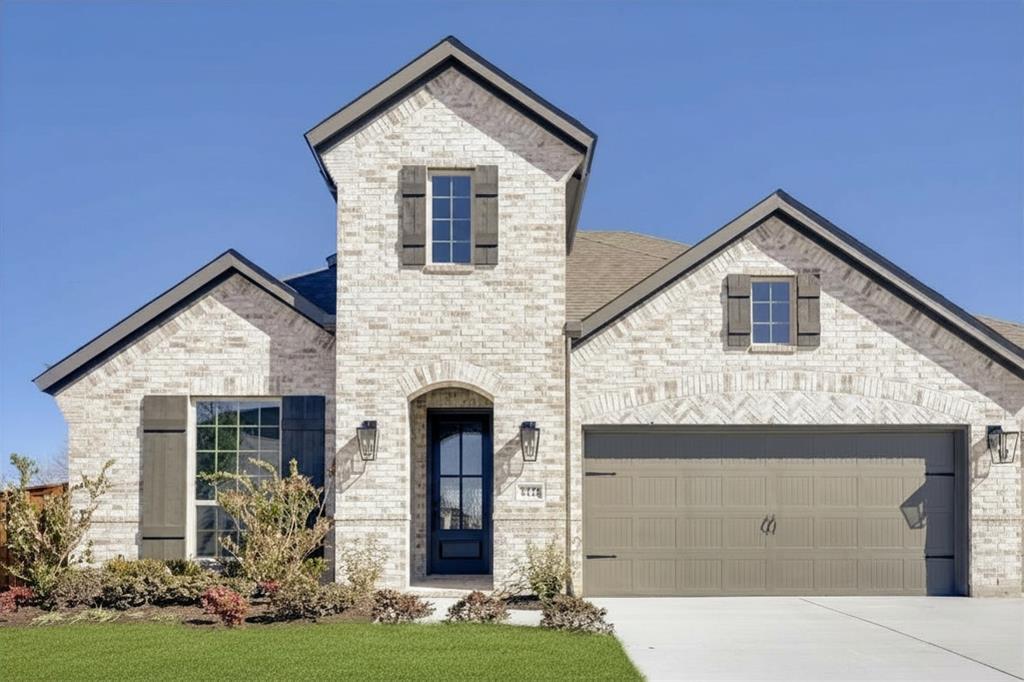 Two-story brick exterior with gabled roof lines and dark-trimmed windows