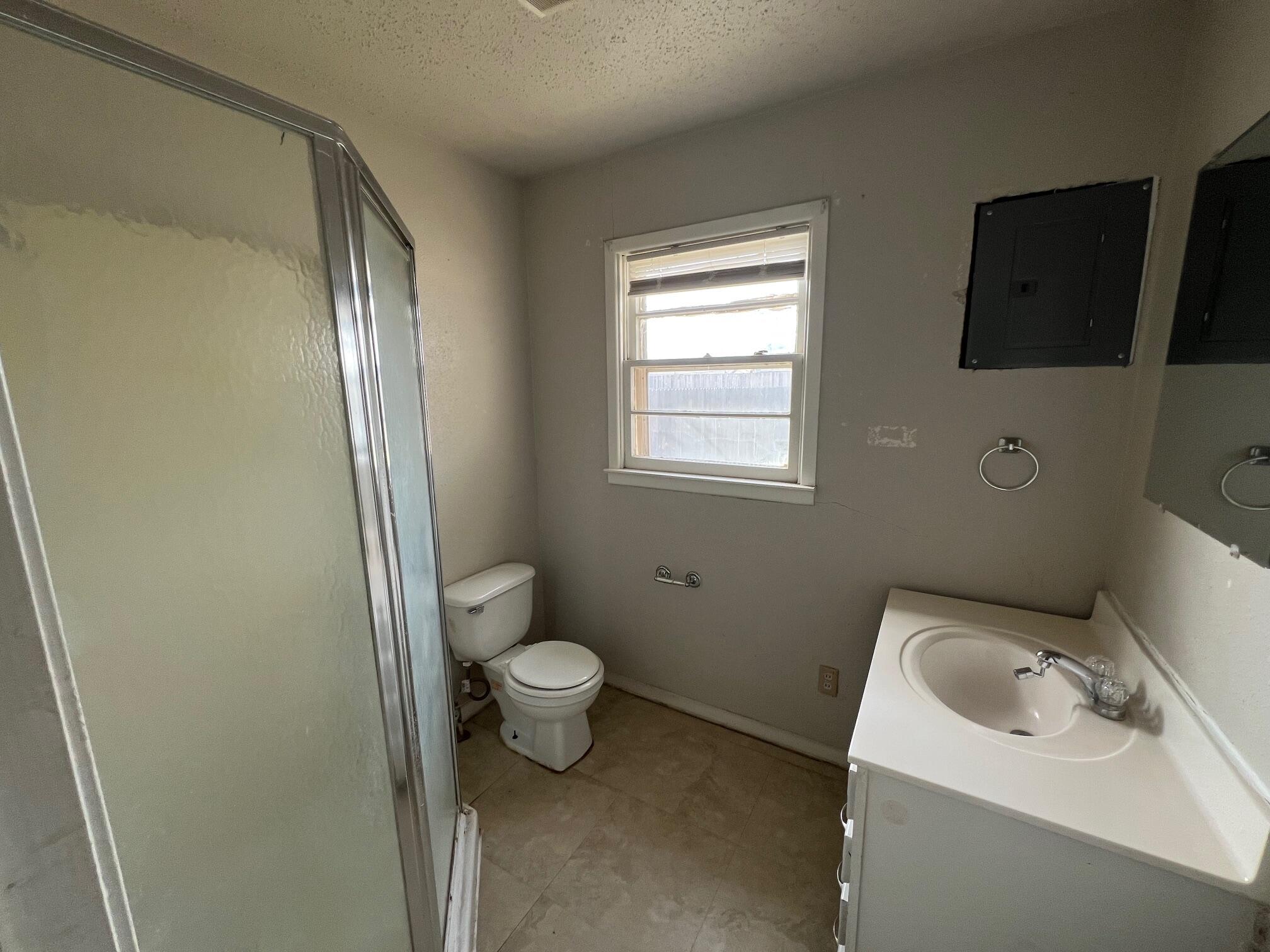 4403 31st Street, Unit B Lubbock, TX 79410 - Photo 6 of 7 a bathroom with a sink toilet and vanity