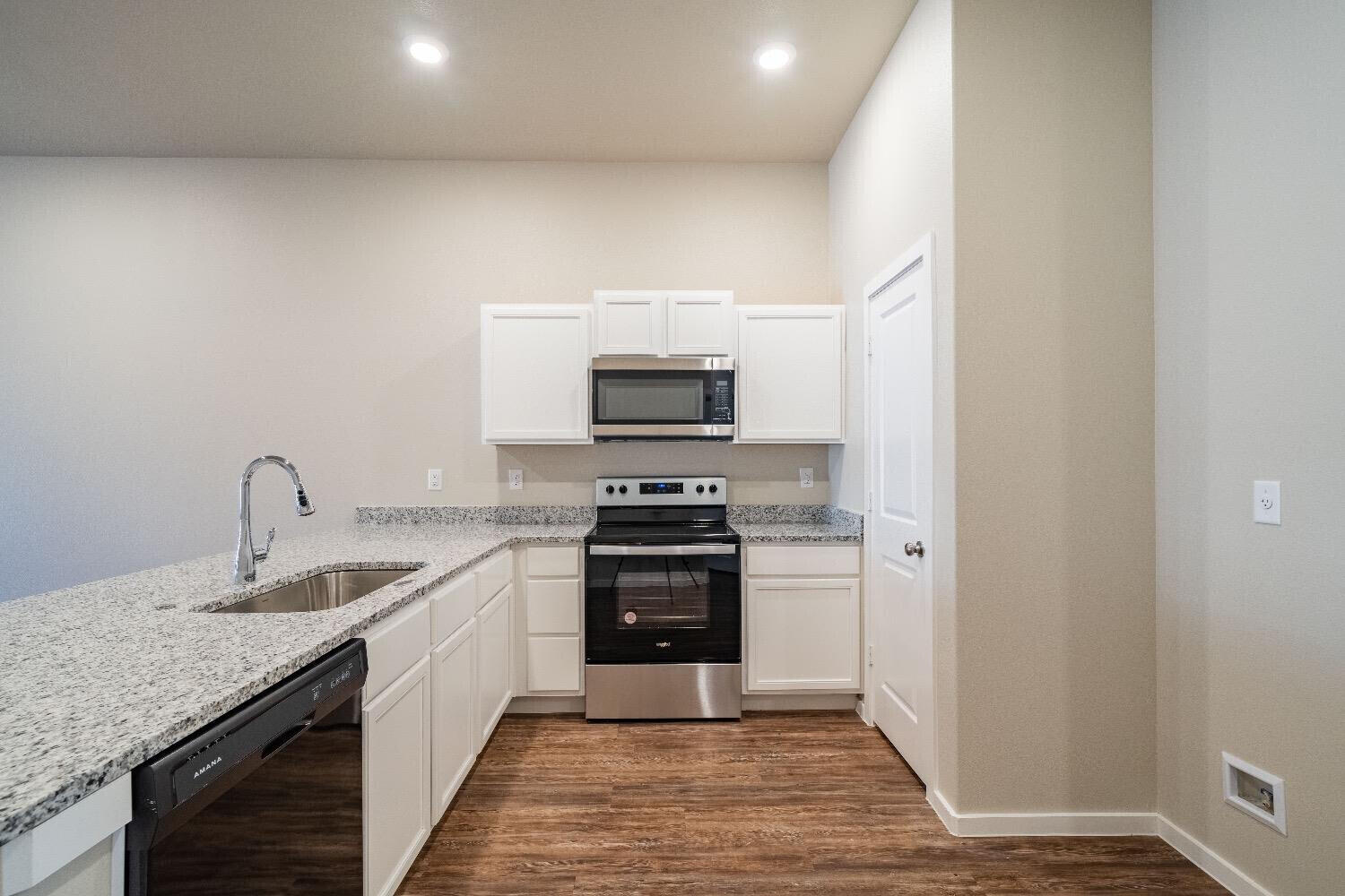 9706 Saratoga Avenue Lubbock, TX 79424 - Photo 2 of 11 a kitchen with a sink and a stove top oven