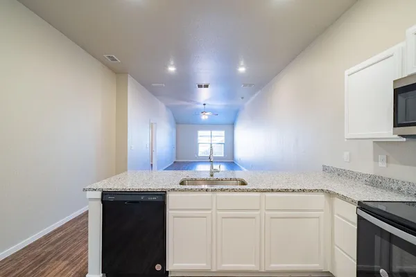 a kitchen with kitchen island granite countertop counter top space a sink and cabinets