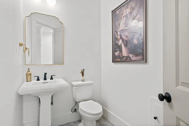 a bathroom with a sink a mirror and a vanity