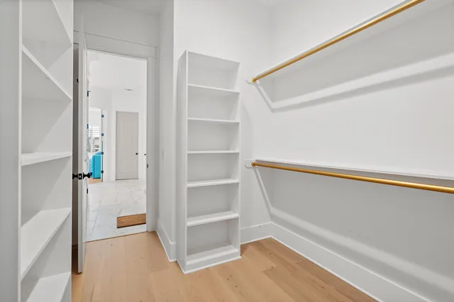 a view of swimming pool with lawn chairs under an umbrella