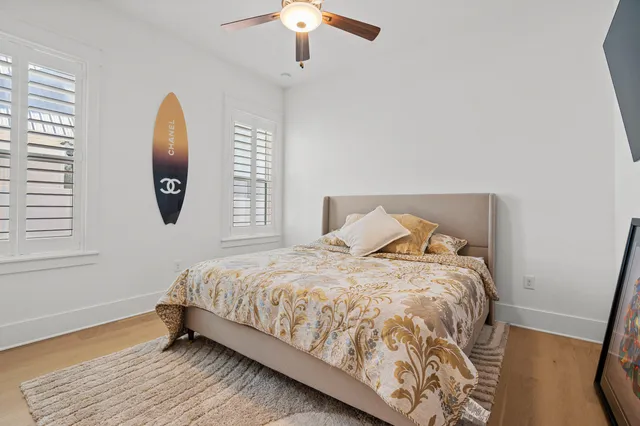 a view of a swimming pool with lawn chairs under an umbrella