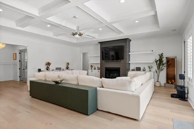 a kitchen with stainless steel appliances granite countertop a dining table chairs refrigerator and microwave