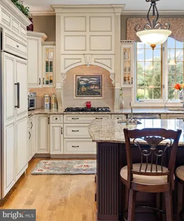 a living room with furniture a rug and a floor to ceiling window