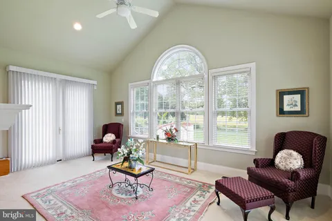 a bathroom with a granite countertop sink a toilet and a mirror