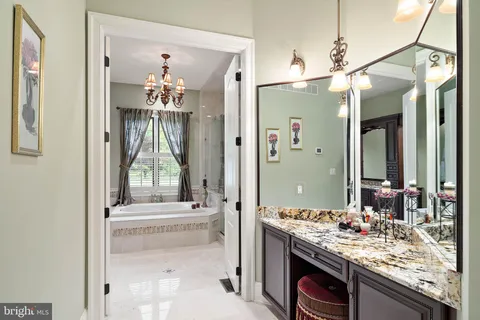 a bathroom with a granite countertop sink a toilet and shower