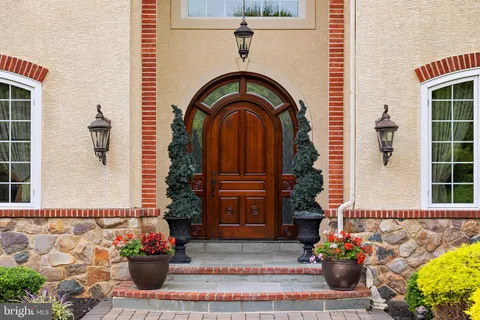 a living room with fireplace furniture and a large window