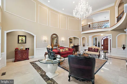 a dining room with furniture chandelier and wooden floor