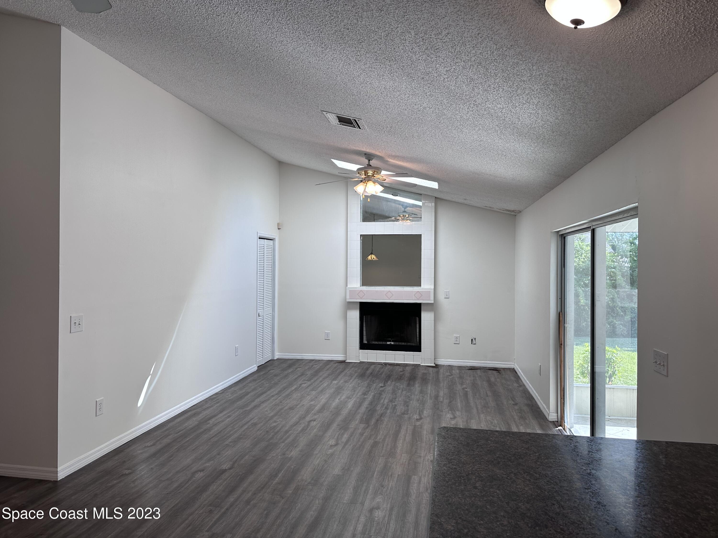 1369 Elcon Drive Melbourne, FL 32904 - Photo 5 of 13 a view of empty room with wooden floor