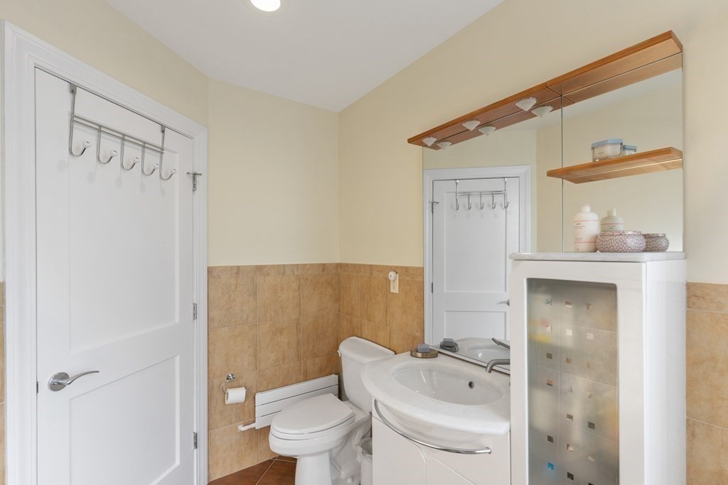20 Strathmore Road, Unit 2 Brookline, MA 02445 - Photo 13 of 28 a bathroom with a toilet a sink and shower
