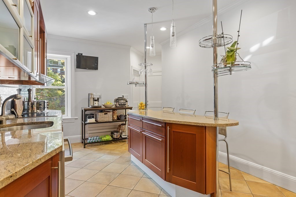 20 Strathmore Road, Unit 2 Brookline, MA 02445 - Photo 9 of 28 a kitchen with stainless steel appliances granite countertop a sink a stove top oven a counter space and cabinets