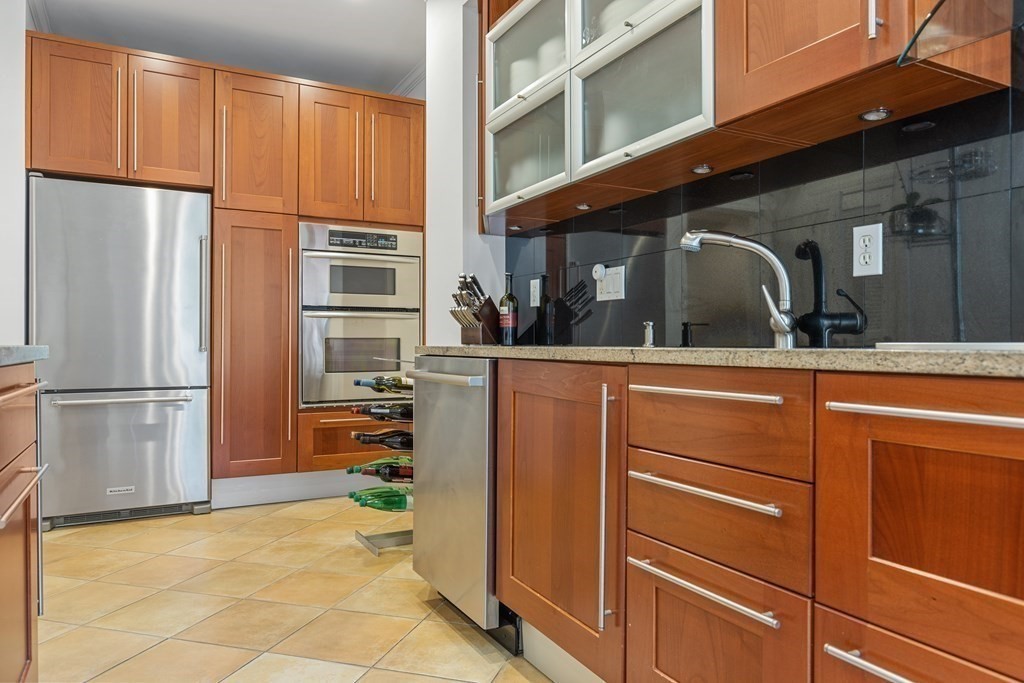 20 Strathmore Road, Unit 2 Brookline, MA 02445 - Photo 10 of 28 a kitchen with stainless steel appliances kitchen island granite countertop a refrigerator and a stove