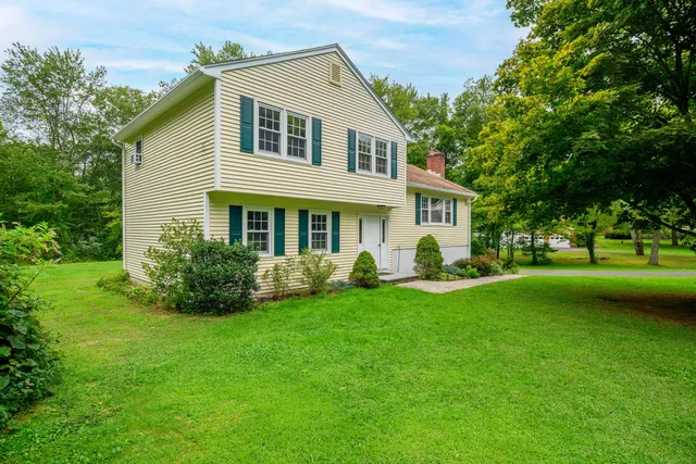 a front view of a house with a garden