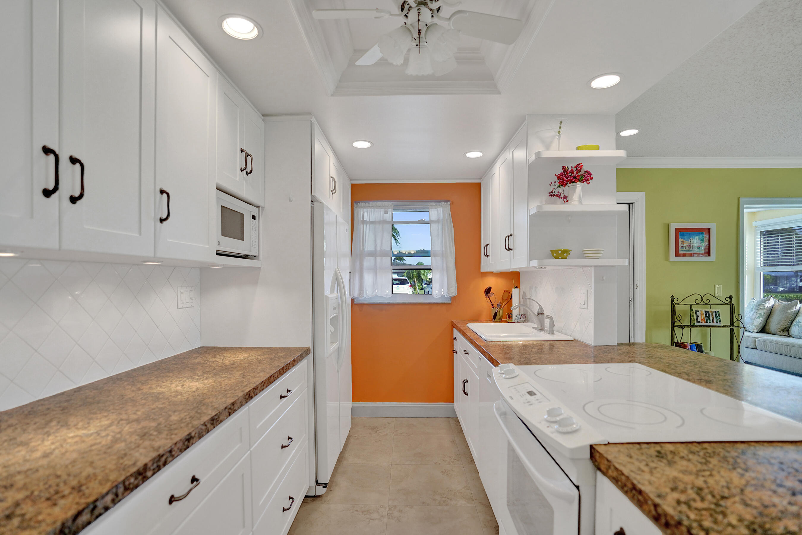 515 High Point Drive, Unit A Delray Beach, FL 33445 - Photo 13 of 60 a large kitchen with stainless steel appliances granite countertop a sink stove and refrigerator