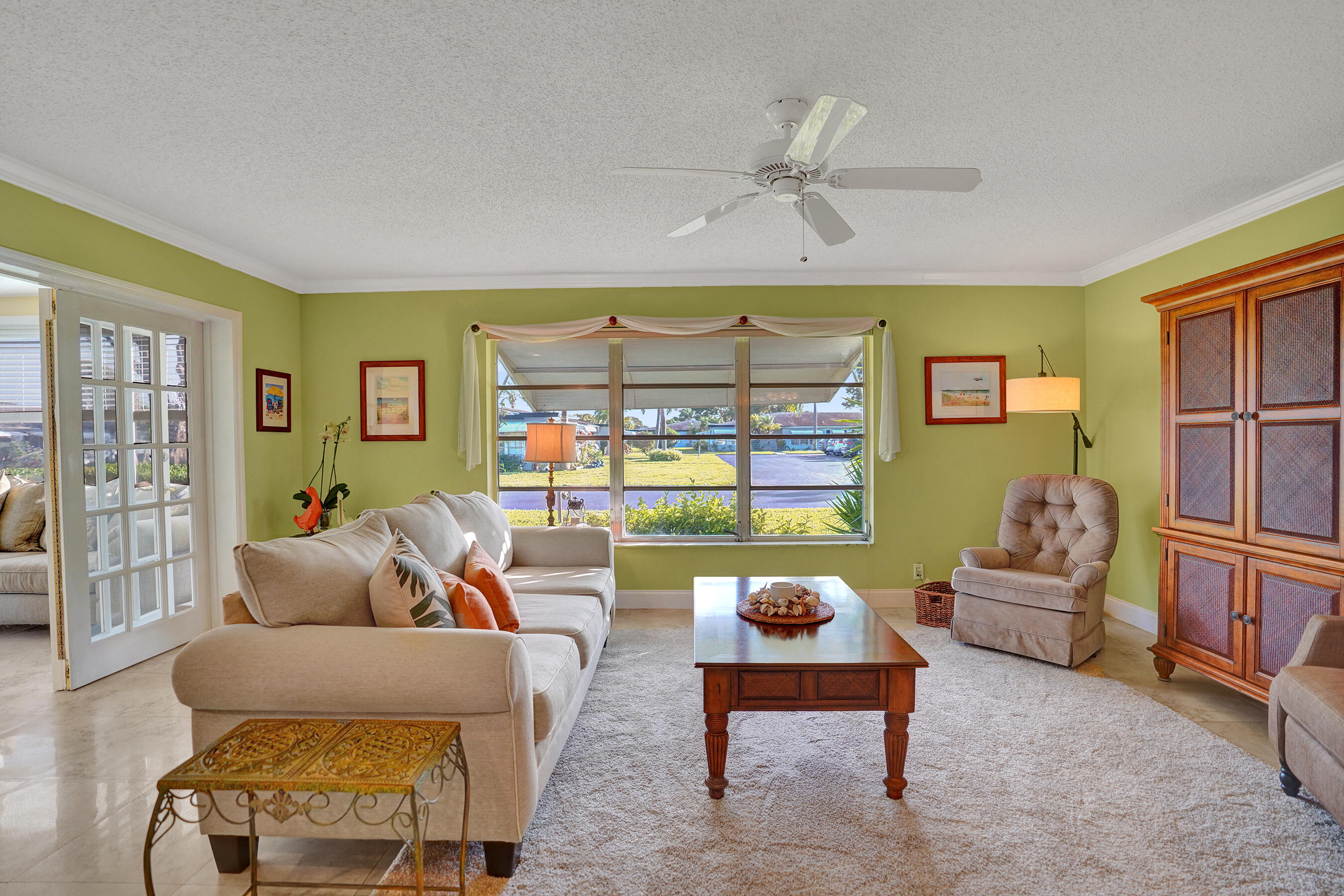 515 High Point Drive, Unit A Delray Beach, FL 33445 - Photo 16 of 60 a living room with furniture and a floor to ceiling window