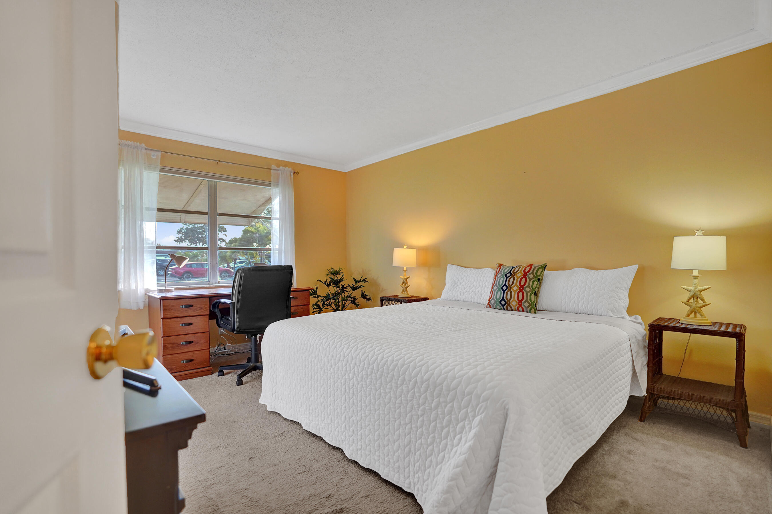 515 High Point Drive, Unit A Delray Beach, FL 33445 - Photo 24 of 60 a bedroom with a bed and wooden floor