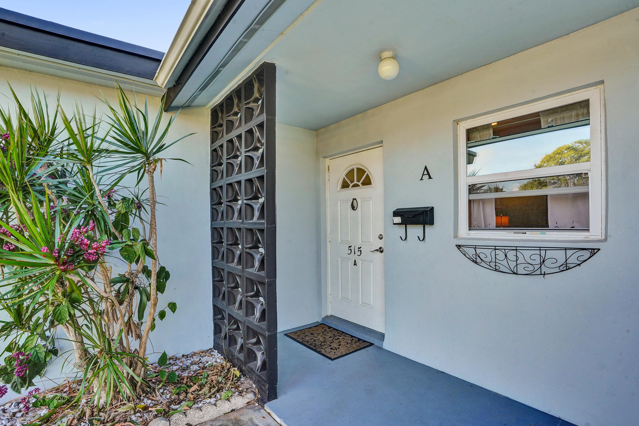 515 High Point Drive, Unit A Delray Beach, FL 33445 - Photo 3 of 60 a house with a potted plant next to a window