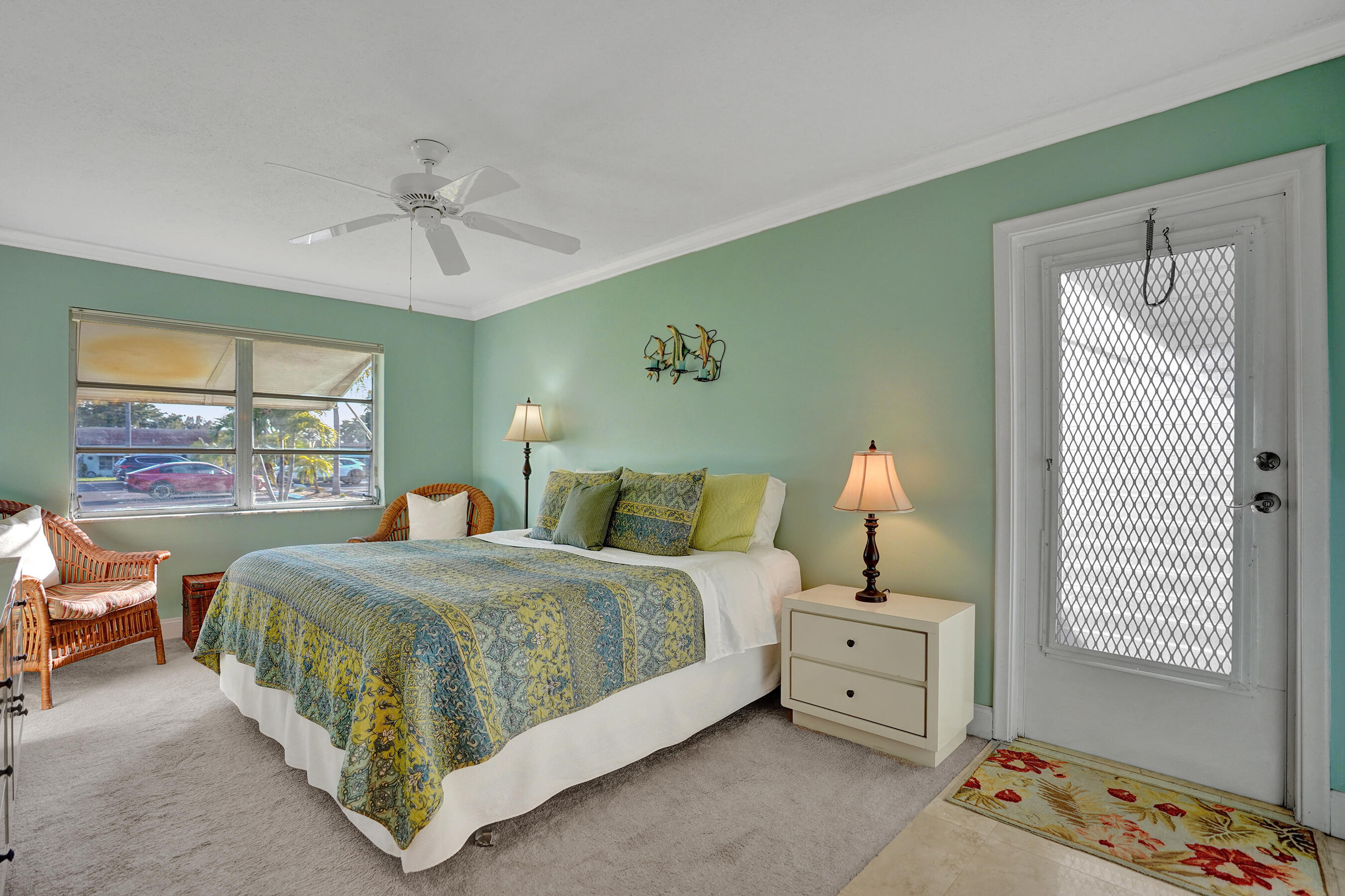 515 High Point Drive, Unit A Delray Beach, FL 33445 - Photo 31 of 60 a bedroom with a bed and a chandelier