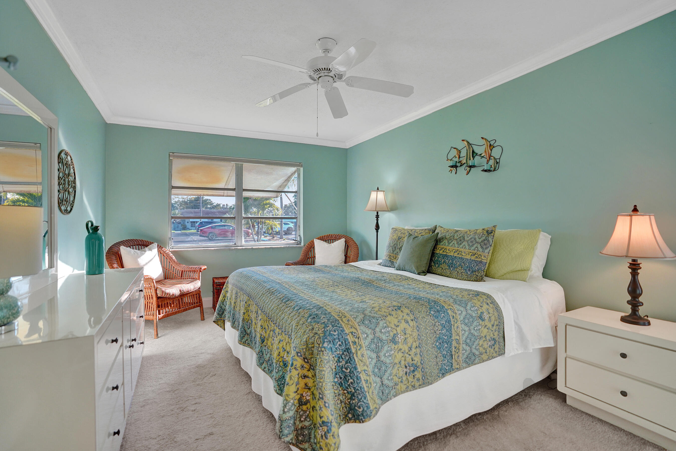 515 High Point Drive, Unit A Delray Beach, FL 33445 - Photo 32 of 60 a bedroom with a bed and a chandelier