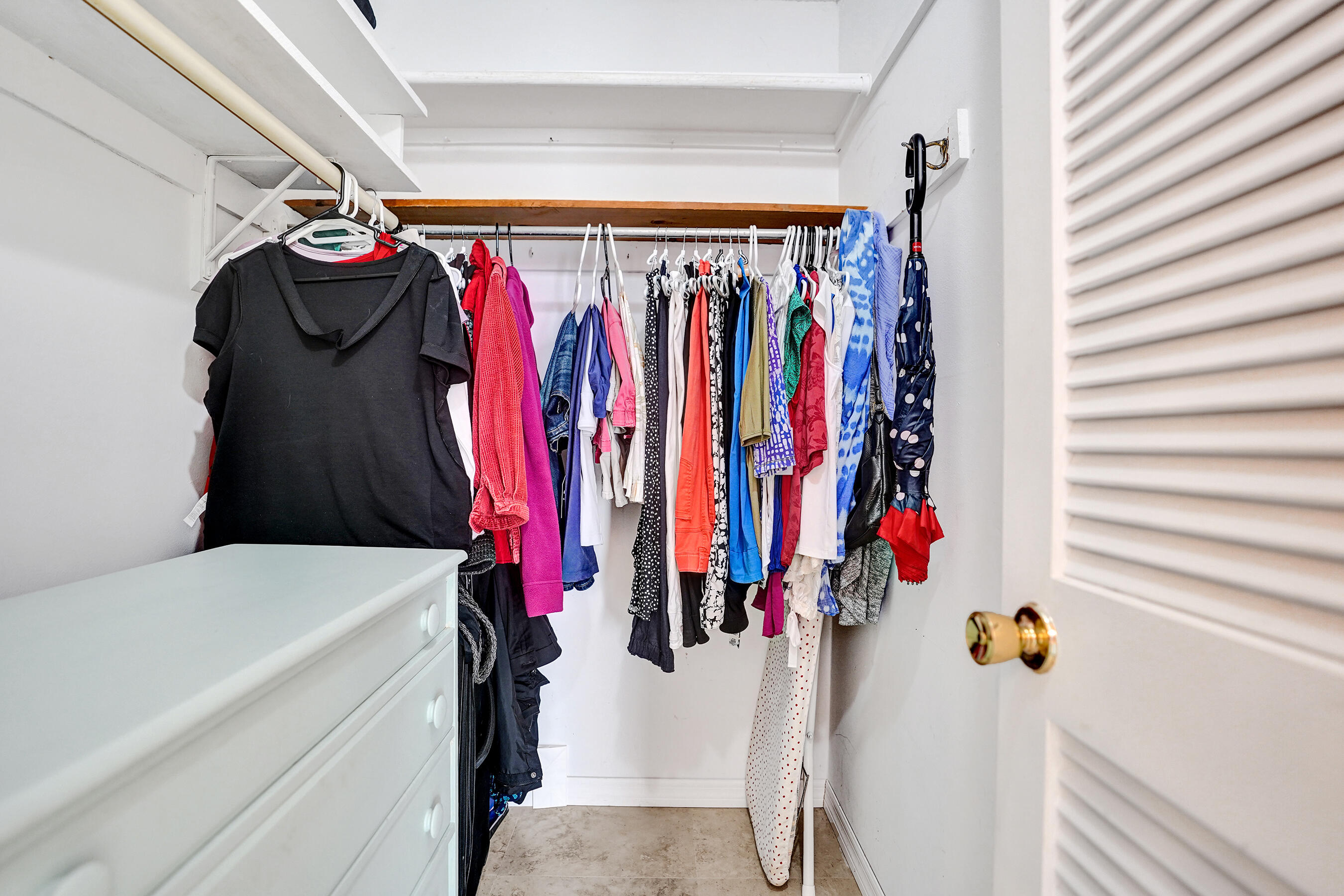515 High Point Drive, Unit A Delray Beach, FL 33445 - Photo 37 of 60 a view of walk in closet with clothes and shoes