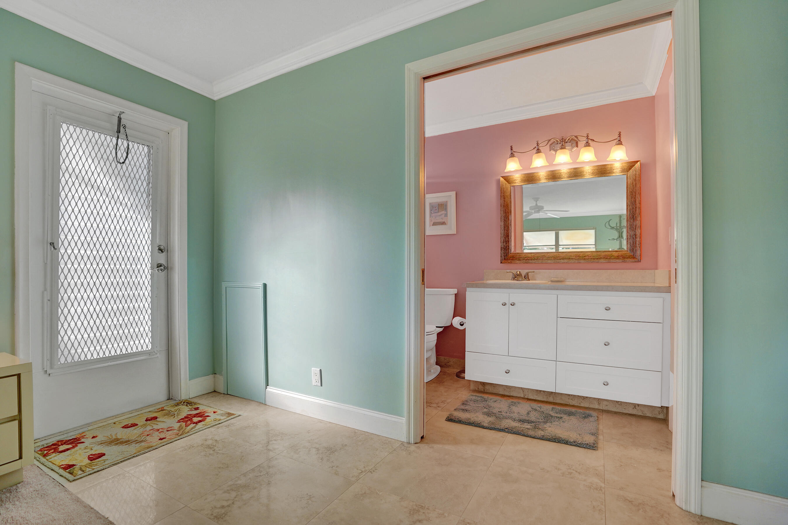 515 High Point Drive, Unit A Delray Beach, FL 33445 - Photo 38 of 60 a view of a bedroom with a window and mirror