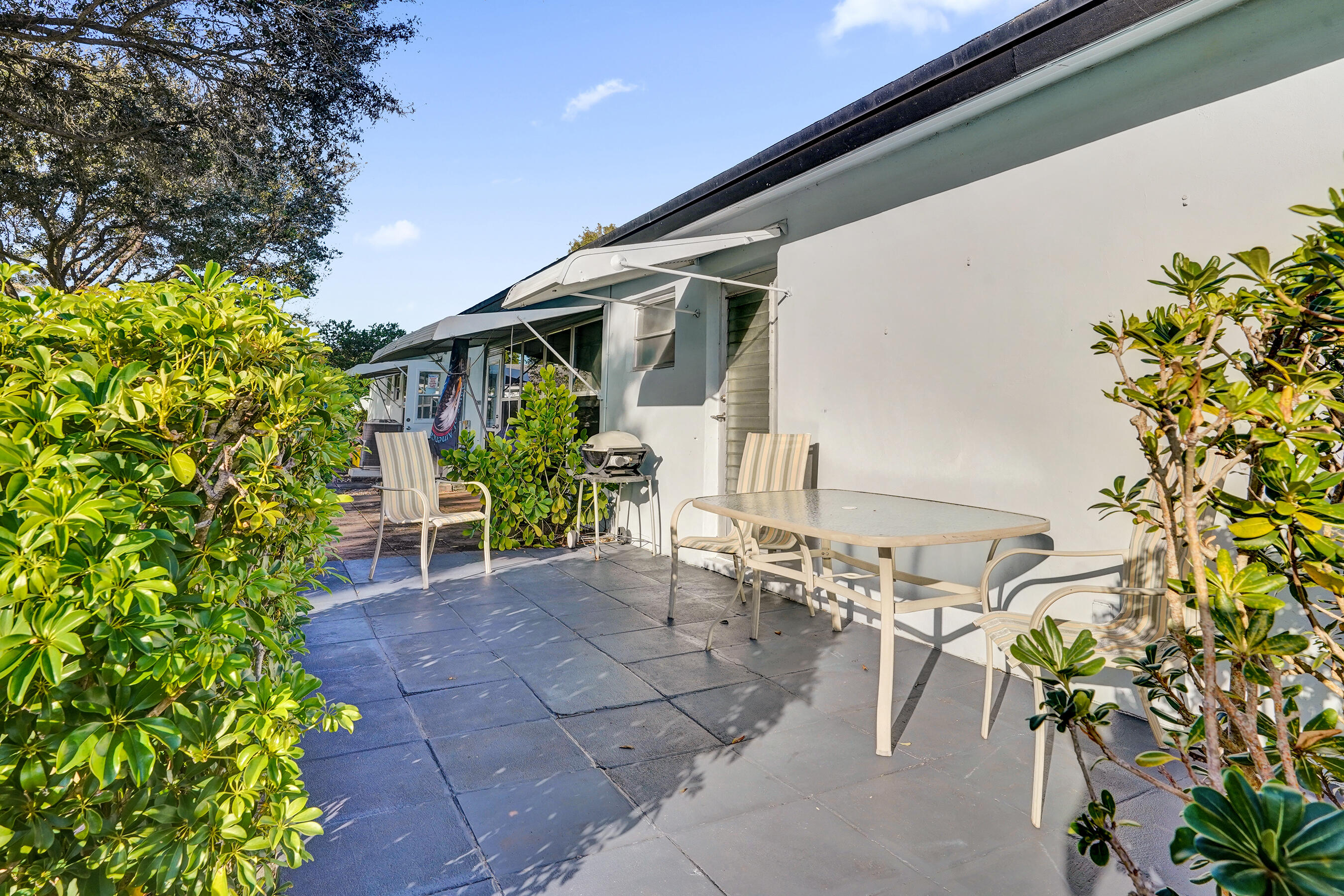 515 High Point Drive, Unit A Delray Beach, FL 33445 - Photo 41 of 60 a view of backyard with outdoor seating and plants