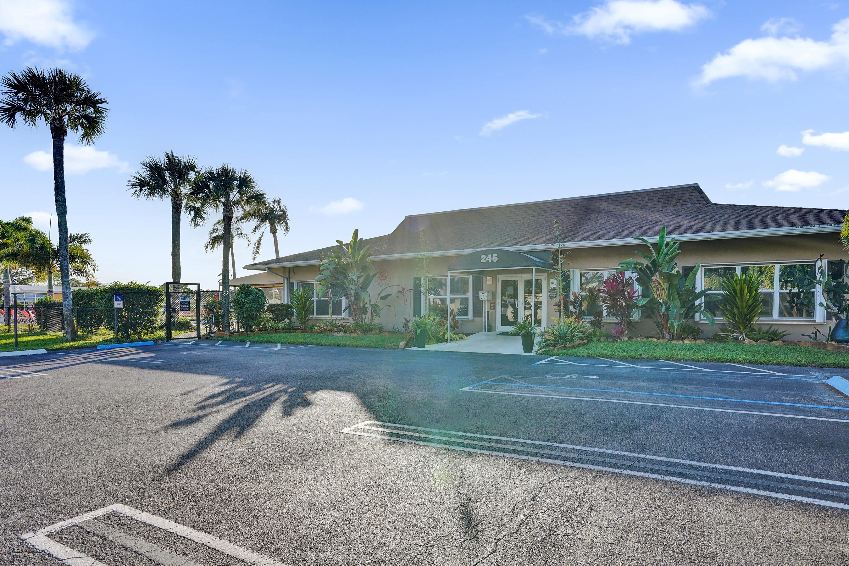 515 High Point Drive, Unit A Delray Beach, FL 33445 - Photo 48 of 60 a front view of a house with a yard and garage