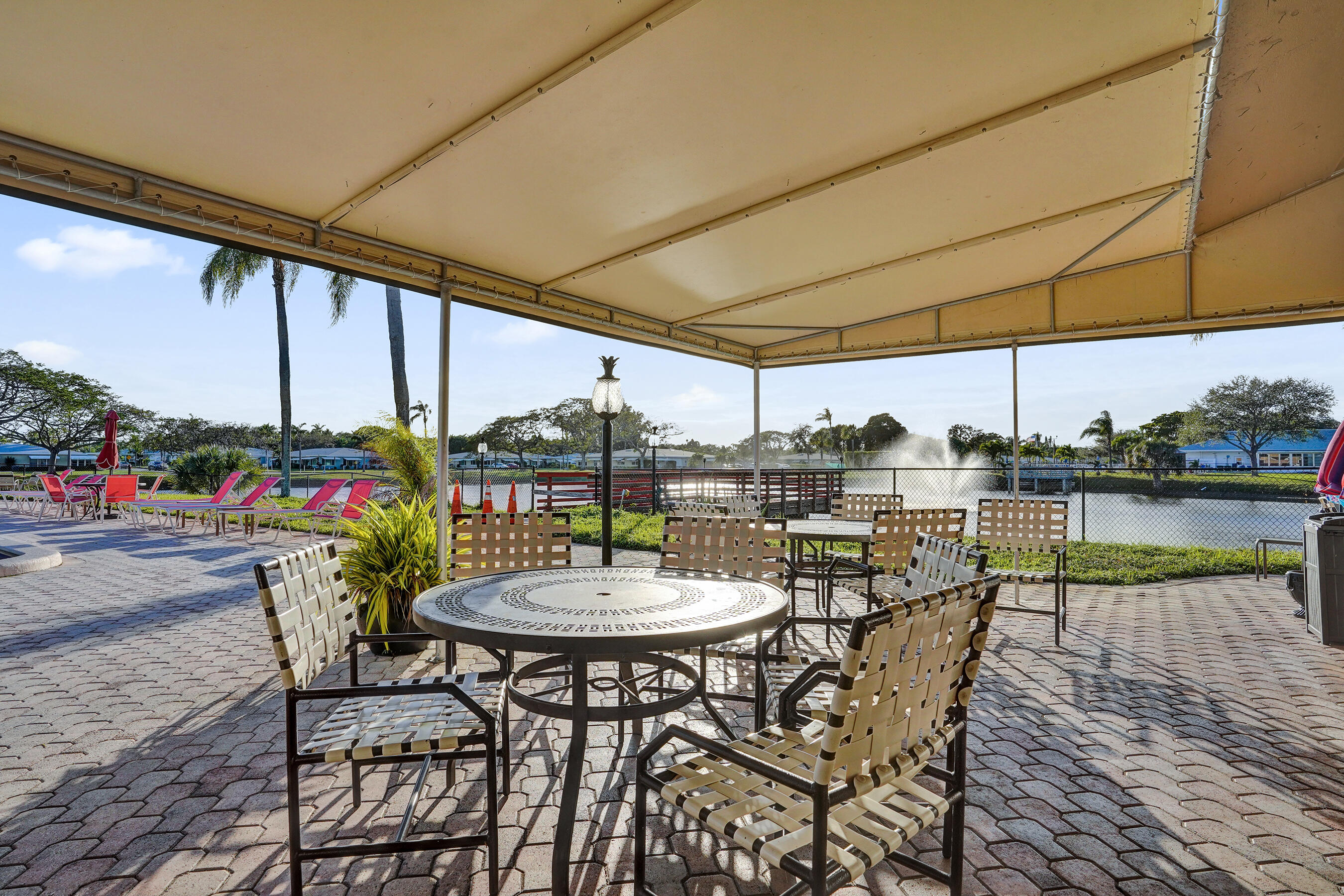 515 High Point Drive, Unit A Delray Beach, FL 33445 - Photo 51 of 60 a view of a patio with a table chairs and a patio