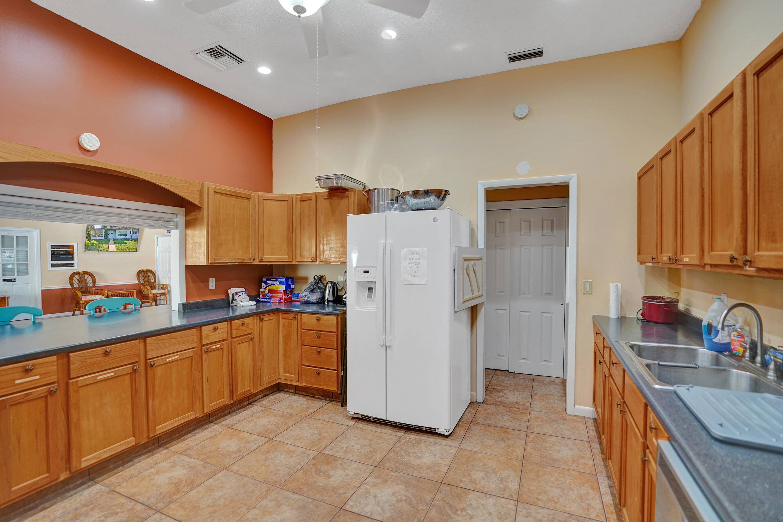 515 High Point Drive, Unit A Delray Beach, FL 33445 - Photo 59 of 60 a kitchen with refrigerator and cabinets