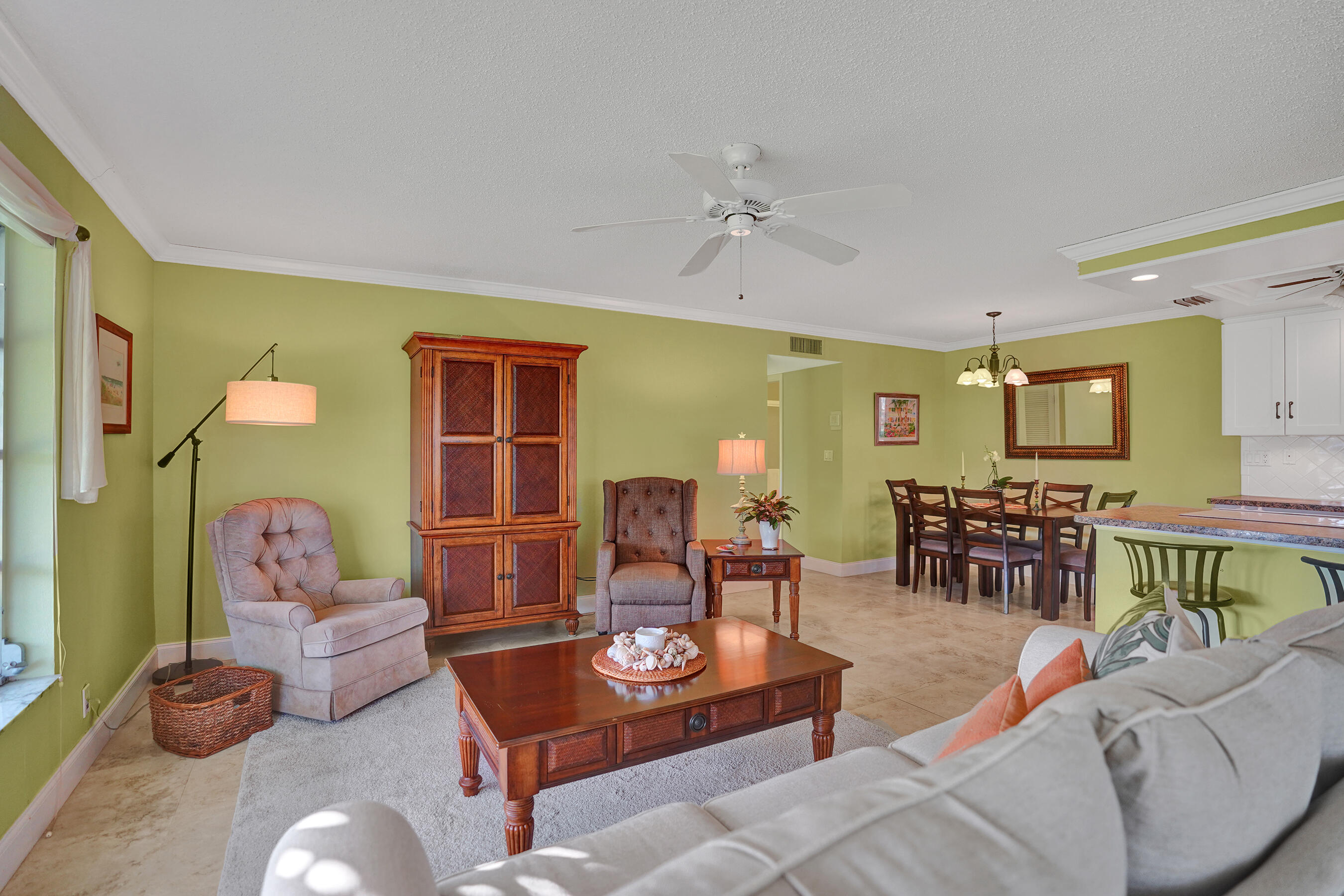 515 High Point Drive, Unit A Delray Beach, FL 33445 - Photo 7 of 60 a living room with furniture a rug and a window