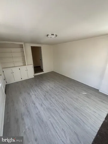 an empty room with wooden floor
