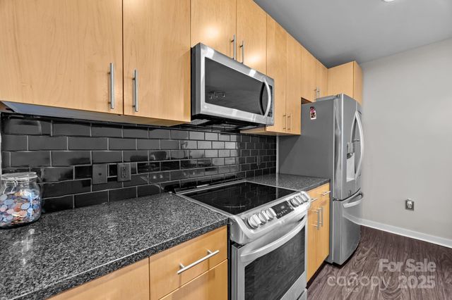a kitchen with granite countertop a sink and a stove top oven