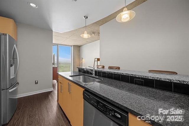 a kitchen with stainless steel appliances a sink a stove and a refrigerator