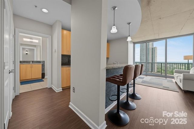 a view of a livingroom with furniture and a floor to ceiling window