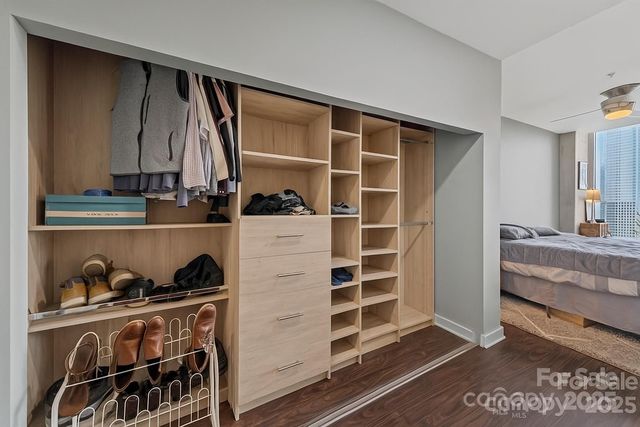 a view of walk in closet with clothes and shoes