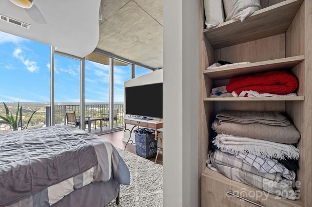 a bedroom with a bed and a flat screen tv