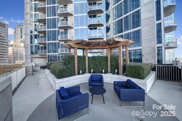 a view of a building and outdoor seating